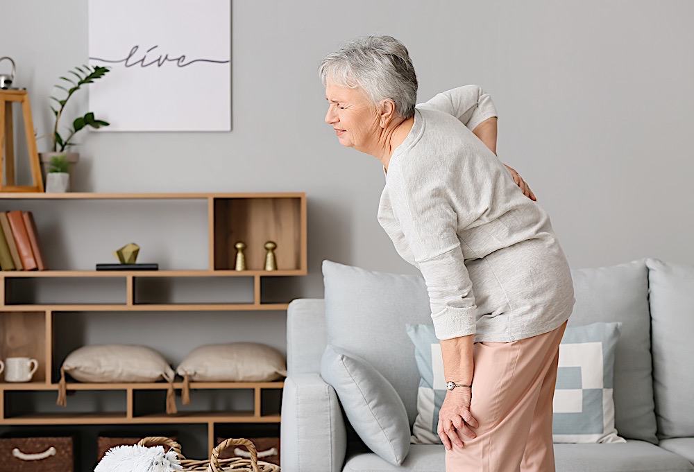 Senior Woman Suffering From Back Pain At Home