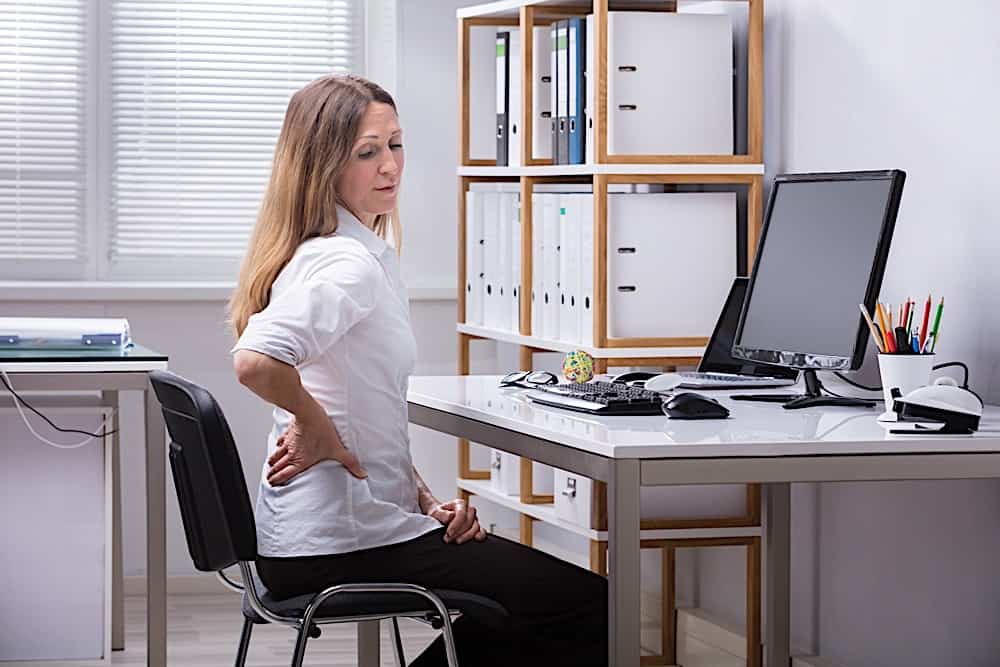 Side View Of A Businesswoman Suffering From Back Pain