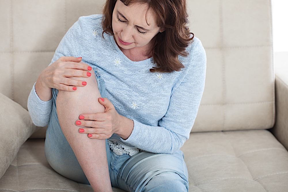Woman Suffering From Pain In Knee, Close Up