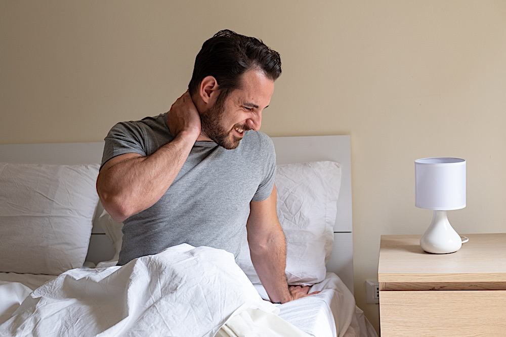 Man Feeling Neck Ache After Sleeping In Bed